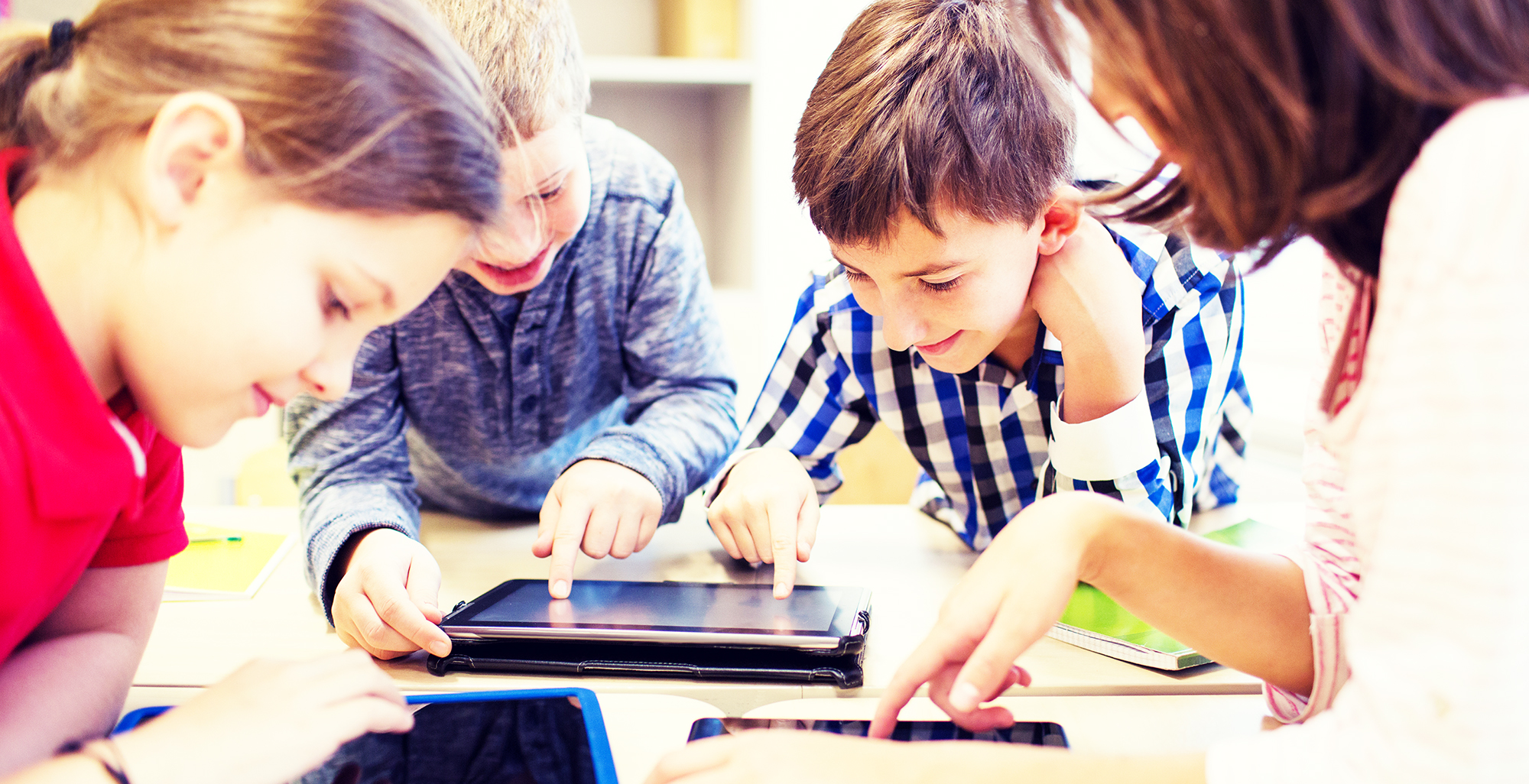 education, elementary school, learning, technology and people concept - group of school kids with tablet pc computer having fun on break in classroom